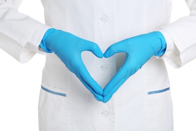 Photo of Doctor making heart shape with hands in medical gloves on white background