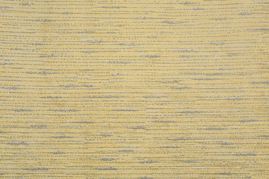 Yellow wallpaper sheet as background, top view
