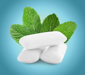 Menthol chewing gum pillows and mint leaves on blue gradient background