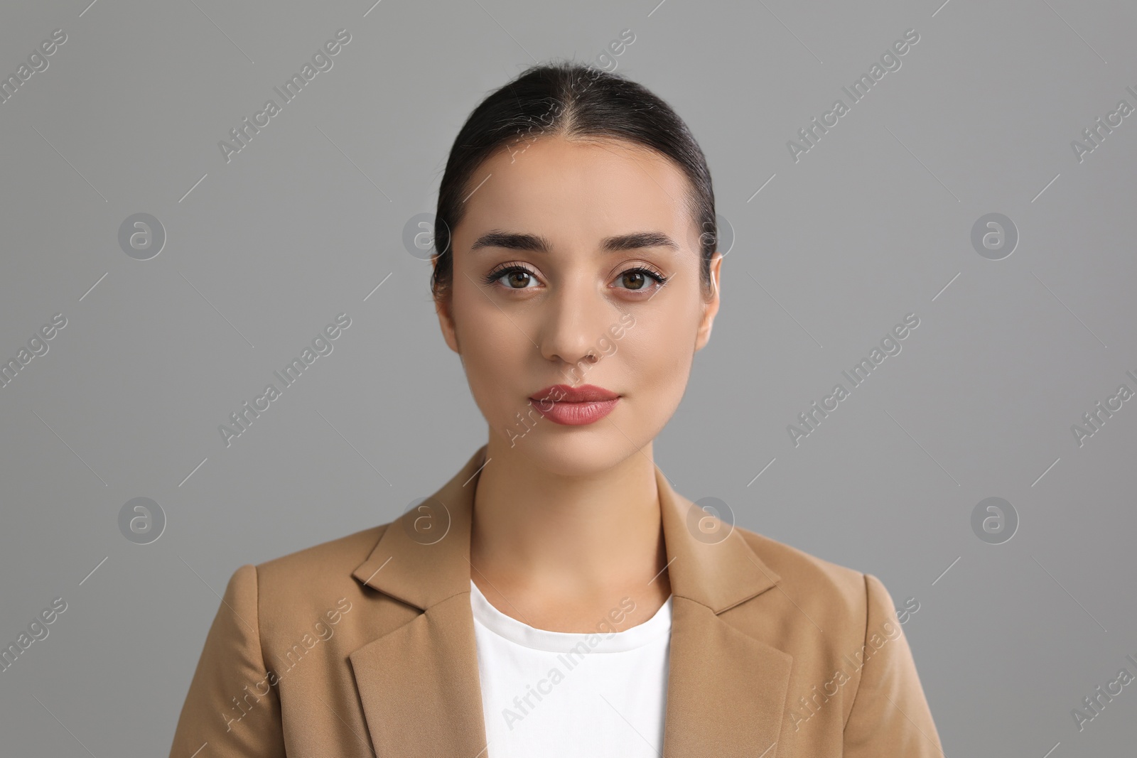 Photo of Portrait of beautiful young woman on grey background