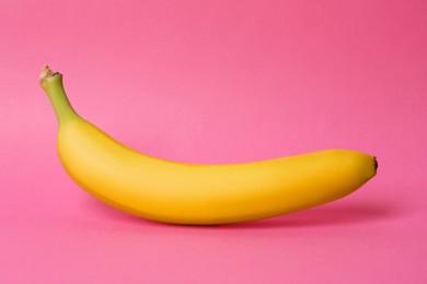 Photo of Ripe sweet yellow banana on pink background
