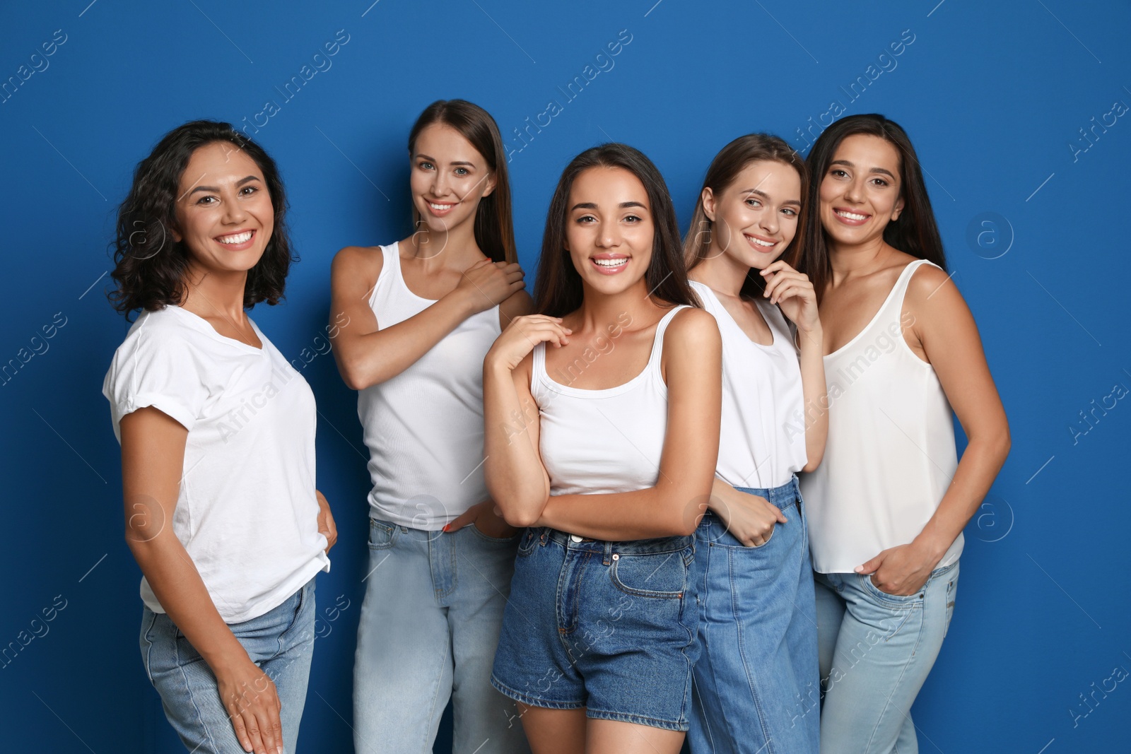 Photo of Happy women on blue background. Girl power concept