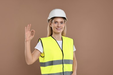 Photo of Engineer in hard hat on brown background