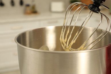 Photo of Modern mixer with cream in kitchen, closeup