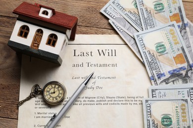 Last Will and Testament, pocket watch, dollar bills, house model and pen on wooden table, above view
