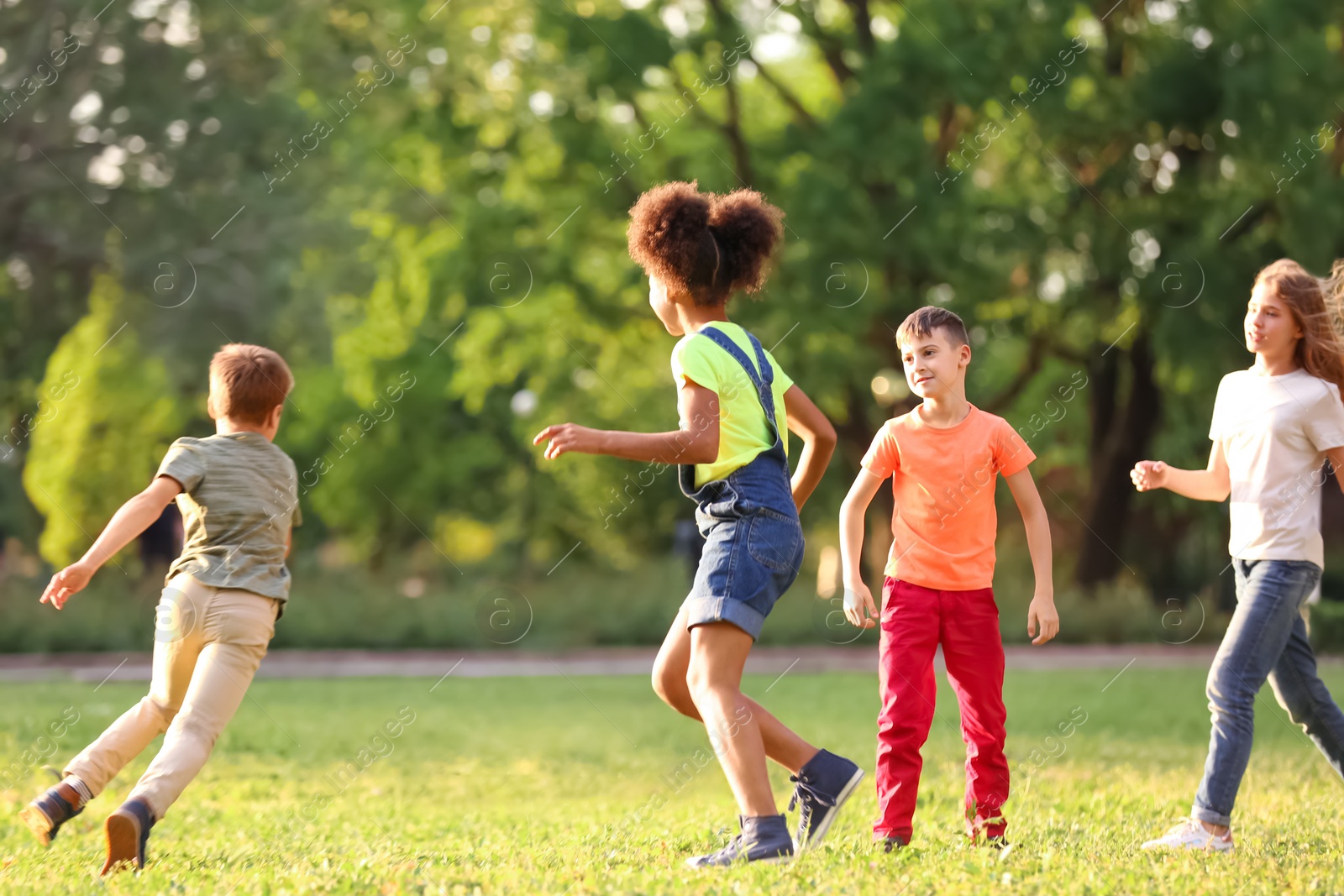 Photo of Cute little children playing together outdoors on sunny day