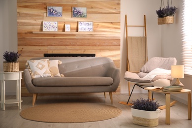 Photo of Stylish sofa and rocking chair in beautiful living room interior