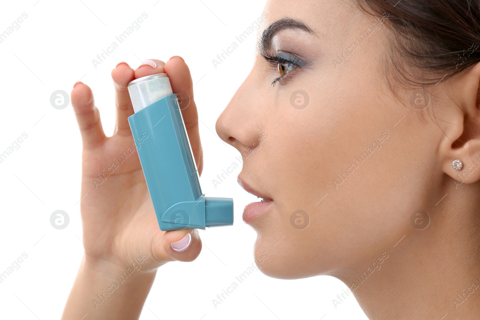 Photo of Young woman using asthma inhaler on white background, closeup