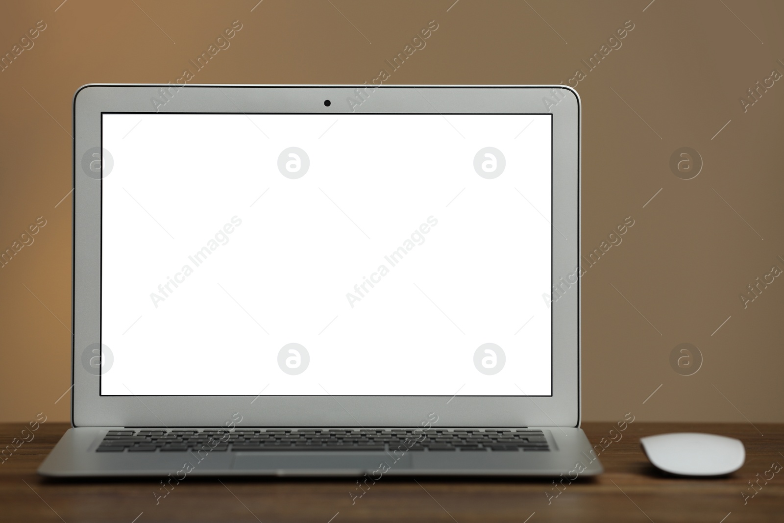 Photo of Laptop with blank screen on table indoors. Space for text