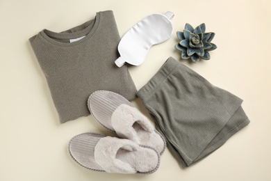 Flat lay composition with house slippers, sleeping mask and pajamas on light background