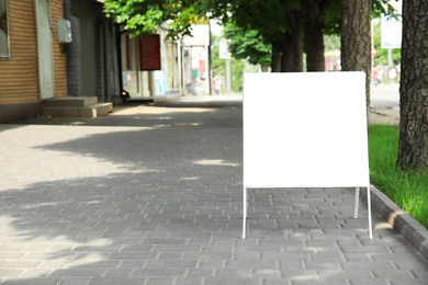 Photo of Blank advertising board on city street. Space for design