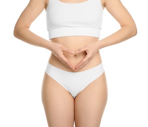 Photo of Gynecology. Woman in underwear making heart with her hands on white background, closeup