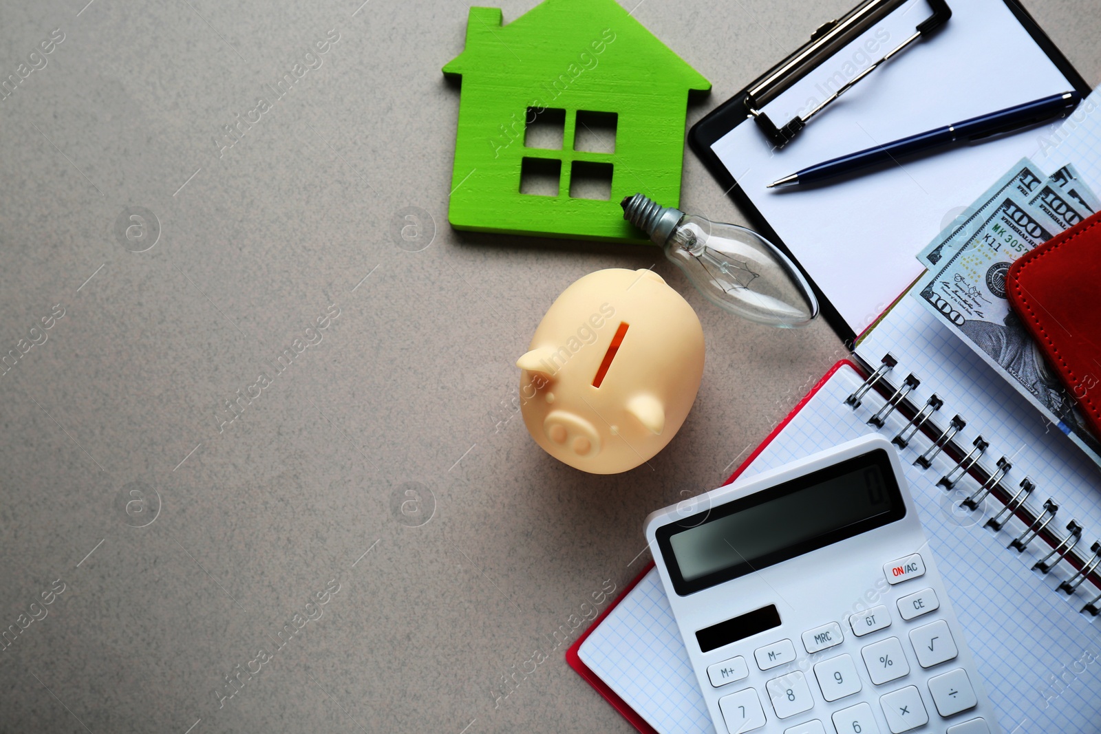 Photo of Flat lay composition with piggy bank and calculator on light grey textured background, space for text. Paying bills concept