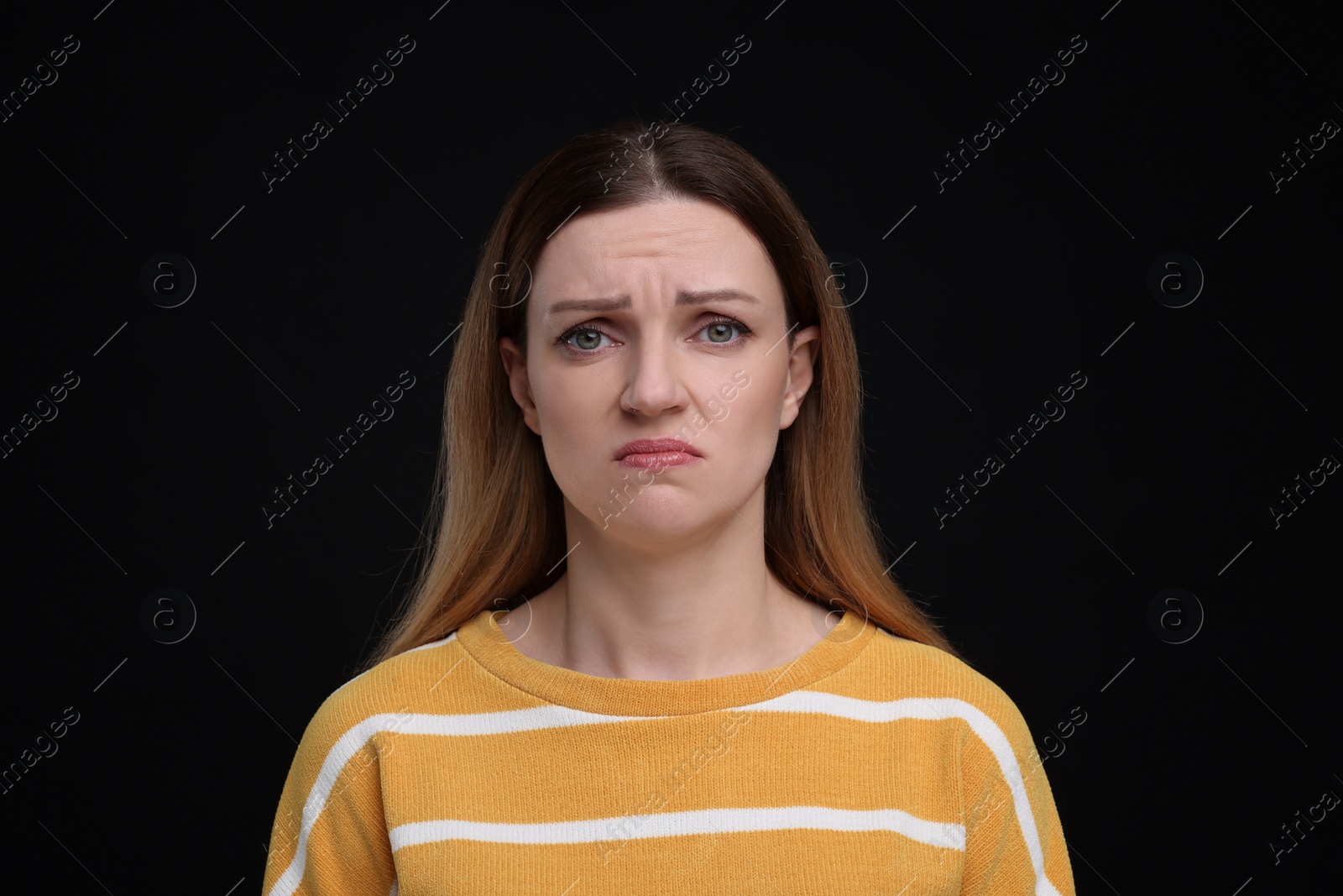 Photo of Portrait of sad woman on black background