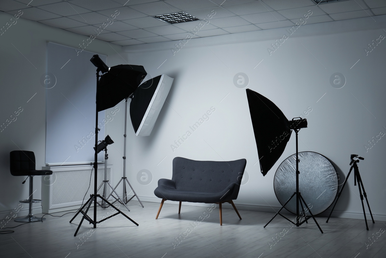 Photo of Modern photo studio with professional lighting equipment