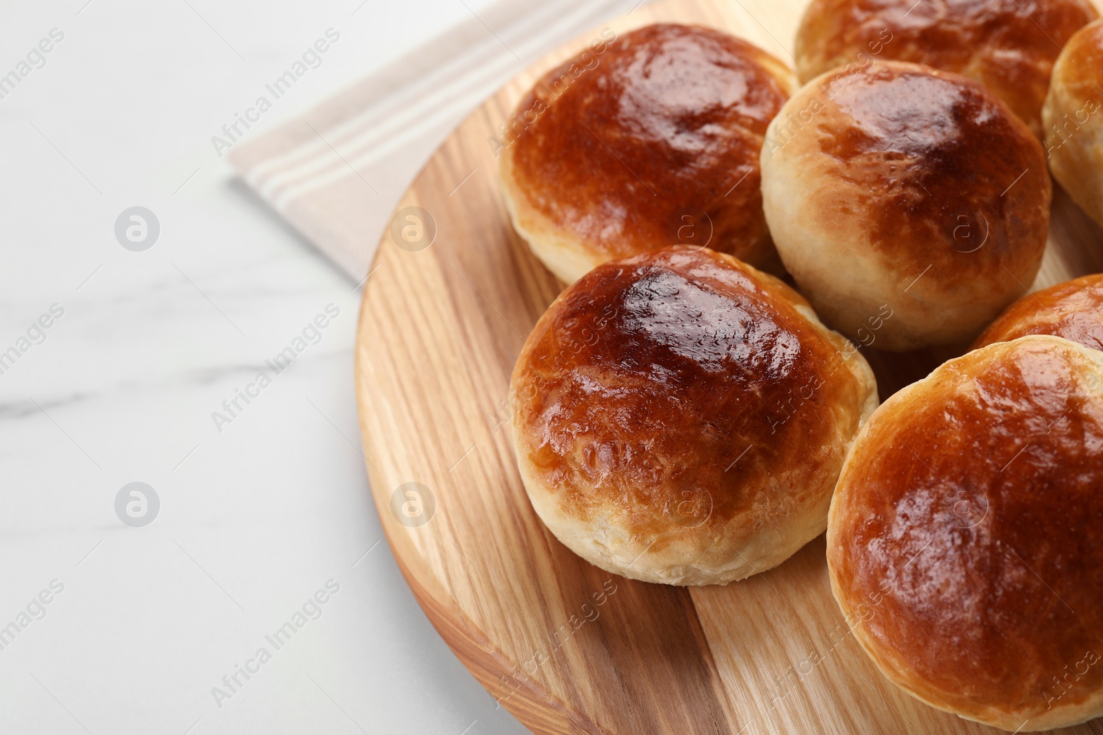 Photo of Tasty scones prepared on soda water on white marble table, space for text