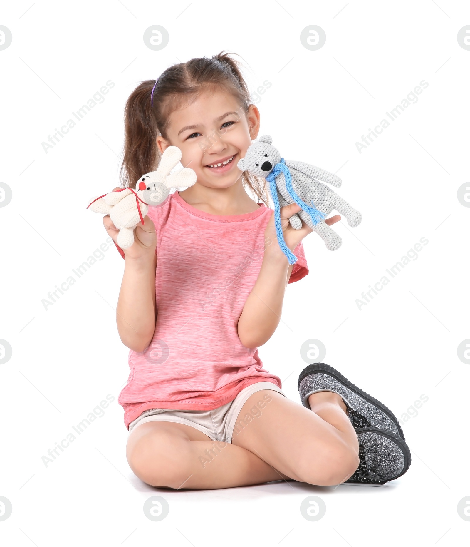 Photo of Little child playing with toy animals on white background. Indoor entertainment