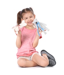 Little child playing with toy animals on white background. Indoor entertainment