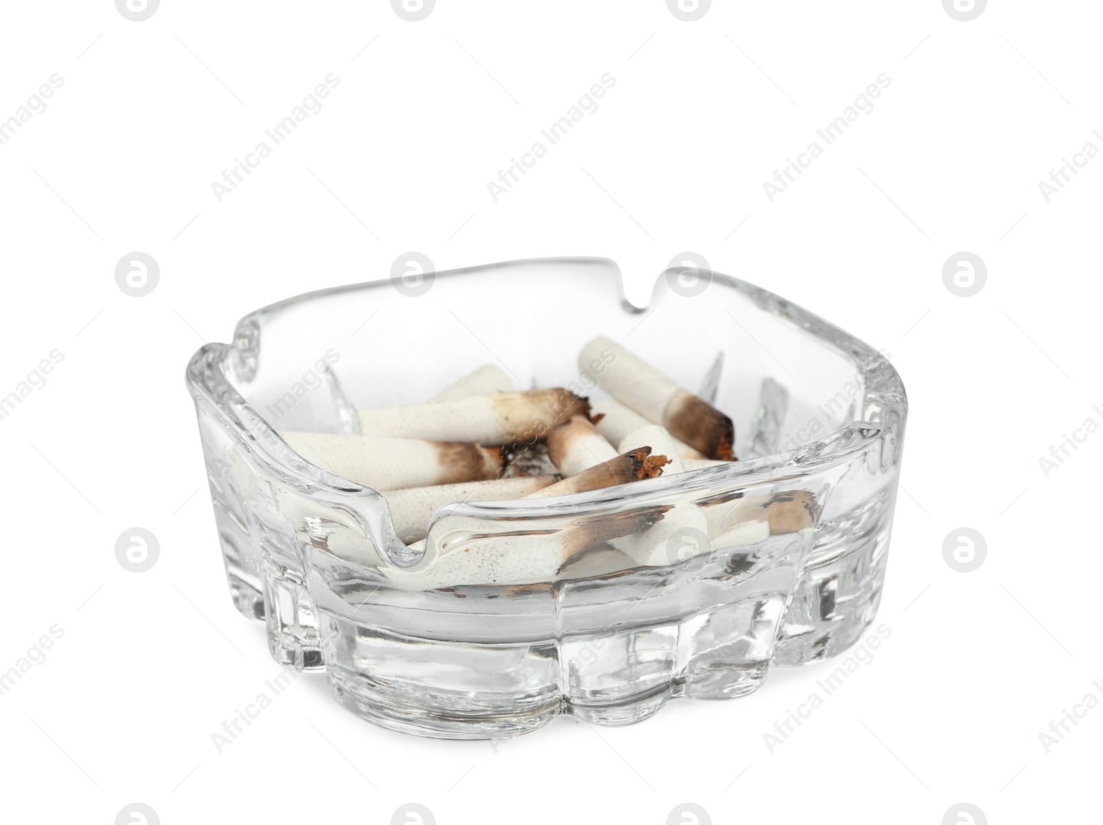 Photo of Glass ashtray with cigarette stubs isolated on white