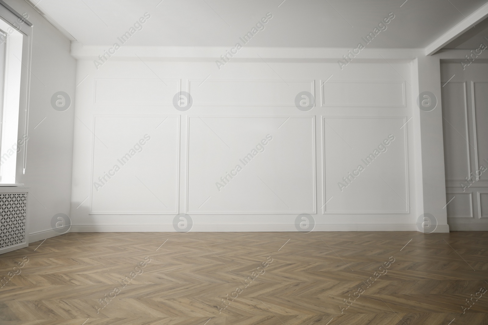 Photo of Parquet floor in light spacious empty room