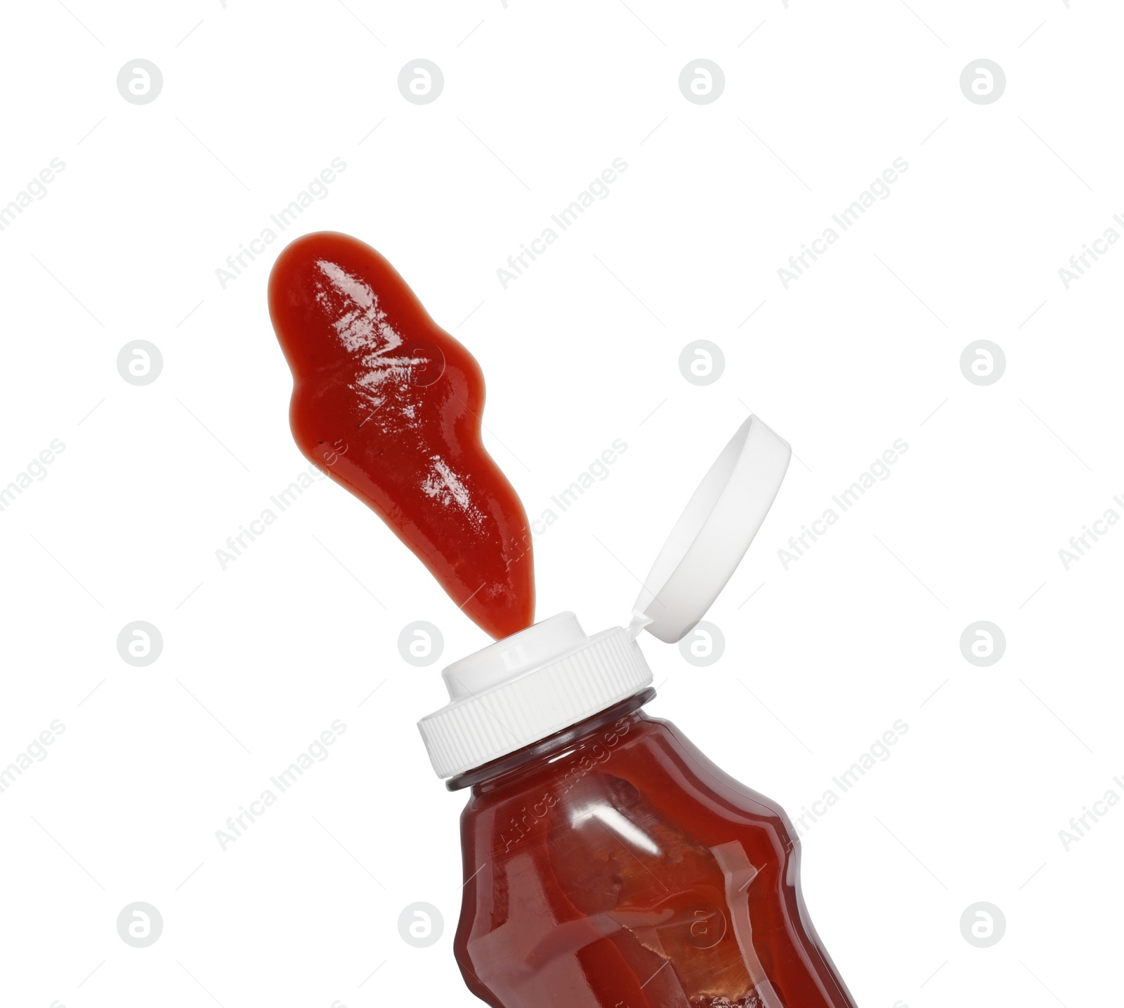 Photo of Squeezed ketchup from bottle isolated on white, top view