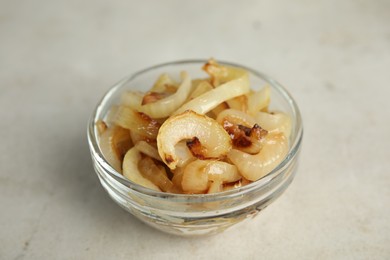 Photo of Tasty fried onion on grey table, closeup