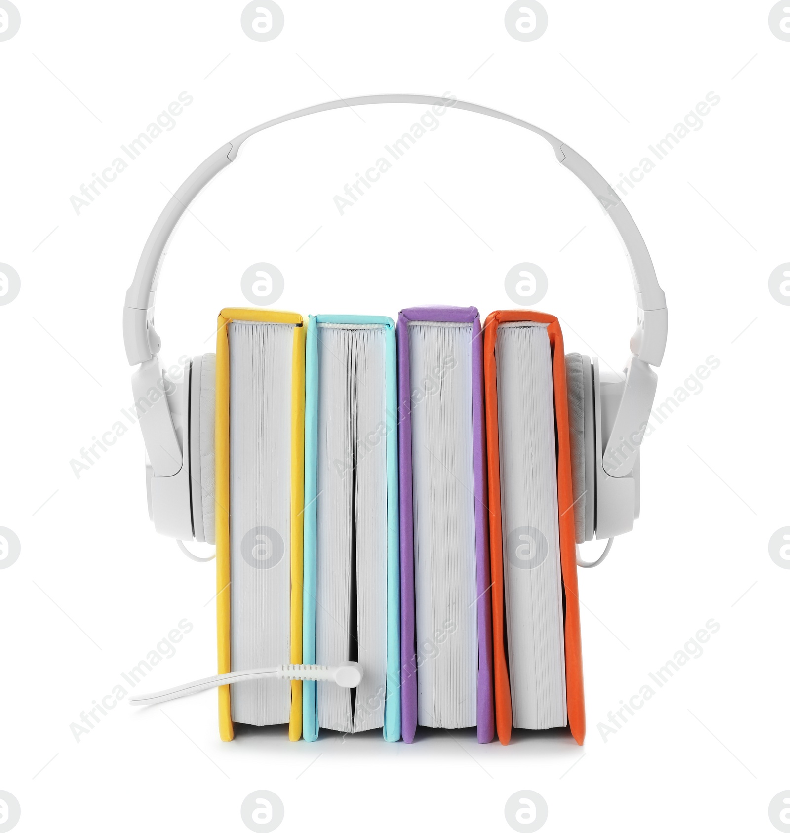 Photo of Modern headphones with hardcover books on white background