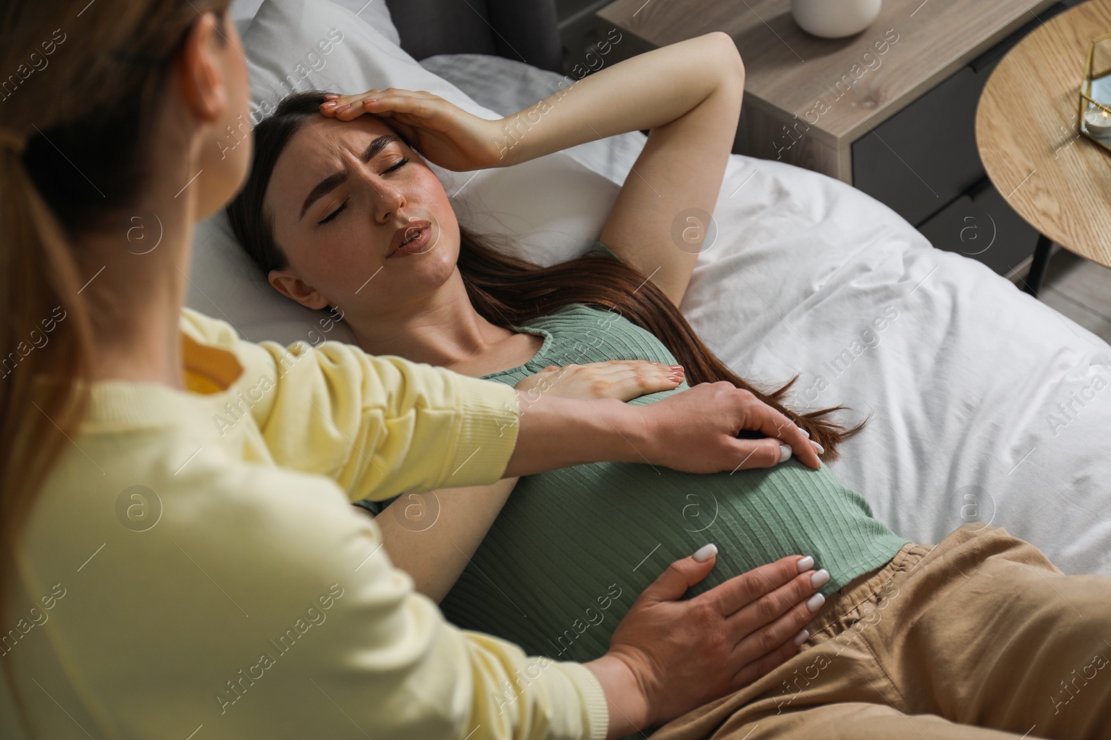Photo of Doula working with pregnant woman indoors. Preparation for child birth