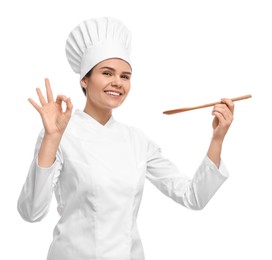 Happy female chef with wooden spoon showing ok gesture on white background