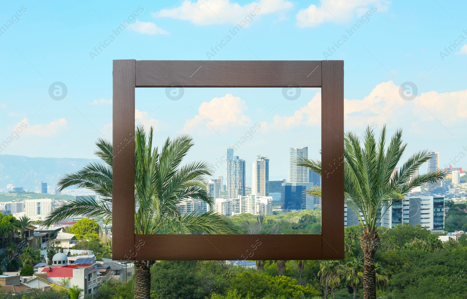 Image of Wooden frame and beautiful city scape under blue sky with clouds