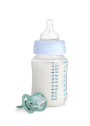 Photo of One feeding bottle with infant formula and pacifier on white background
