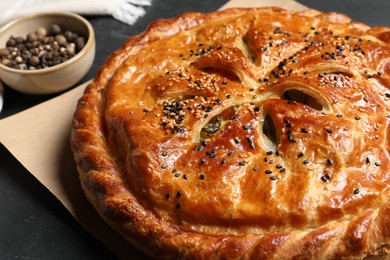 Photo of Tasty homemade pie with filling on grey table, closeup