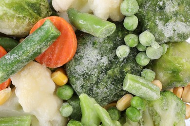 Photo of Mix of different frozen vegetables as background, top view