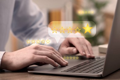 Image of Man leaving service feedback using laptop at table, closeup. Stars near device