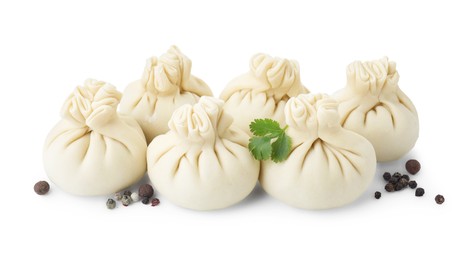 Photo of Uncooked khinkali (dumplings) and spices isolated on white. Georgian cuisine