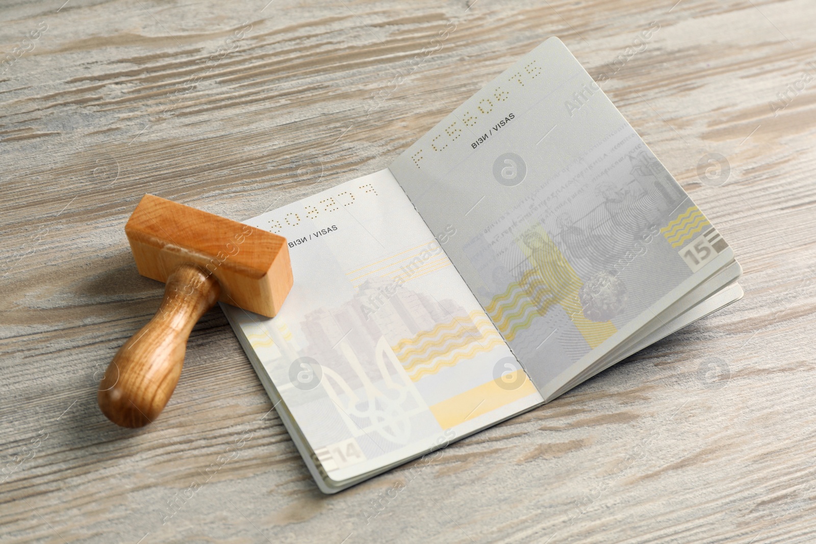 Photo of Moldova, Ceadir-Lunga - June 13, 2022: Passport and stamp on wooden table