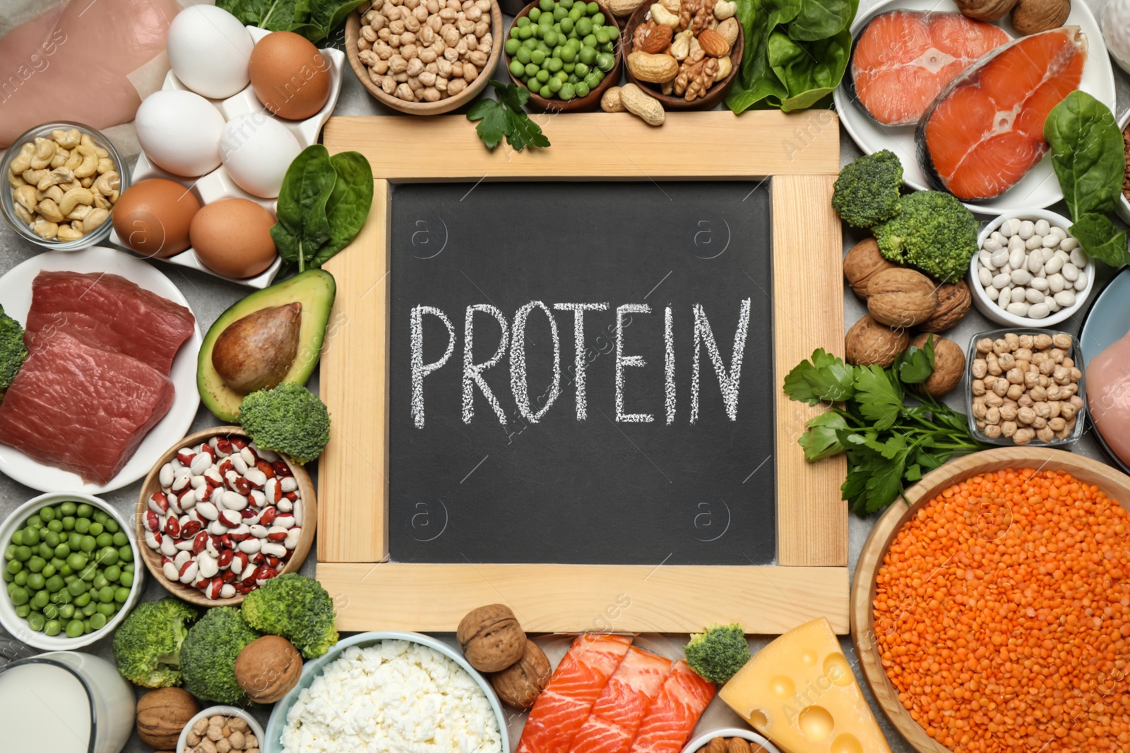 Photo of Chalkboard with word PROTEIN and different products on table, flat lay