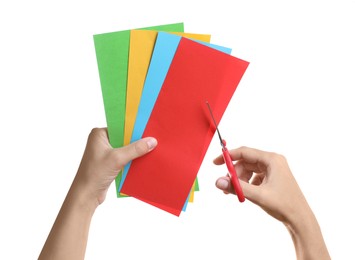 Woman cutting color sheets of paper with scissors on white background, closeup