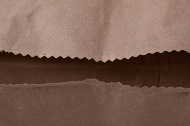 Open kraft paper bag as background, closeup