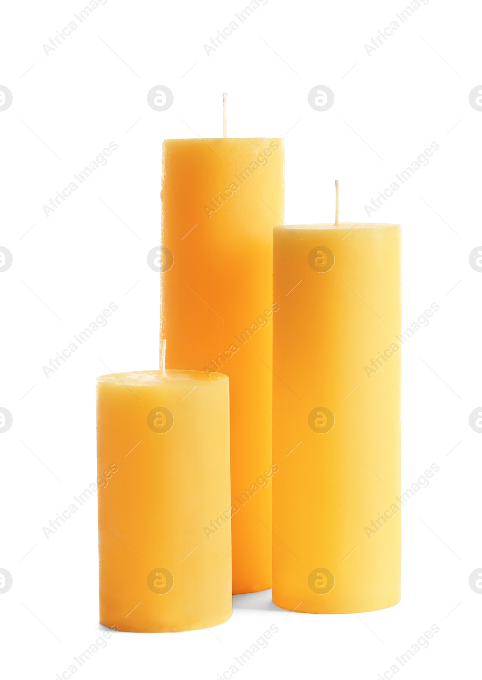 Photo of Yellow pillar wax candles on white background