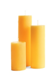 Photo of Yellow pillar wax candles on white background