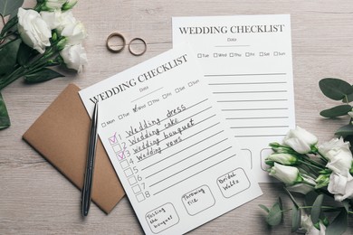 Photo of Flat lay composition with Wedding Checklists and planner on white wooden table