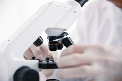 Photo of Scientist with modern microscope at table, closeup. Medical research