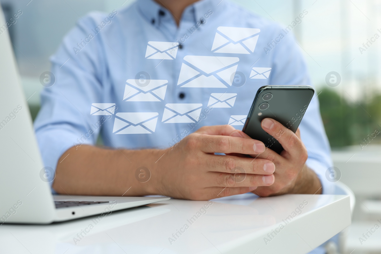 Image of Man with smartphone chatting at table indoors, closeup. Many illustrations of envelope as incoming messages out of device