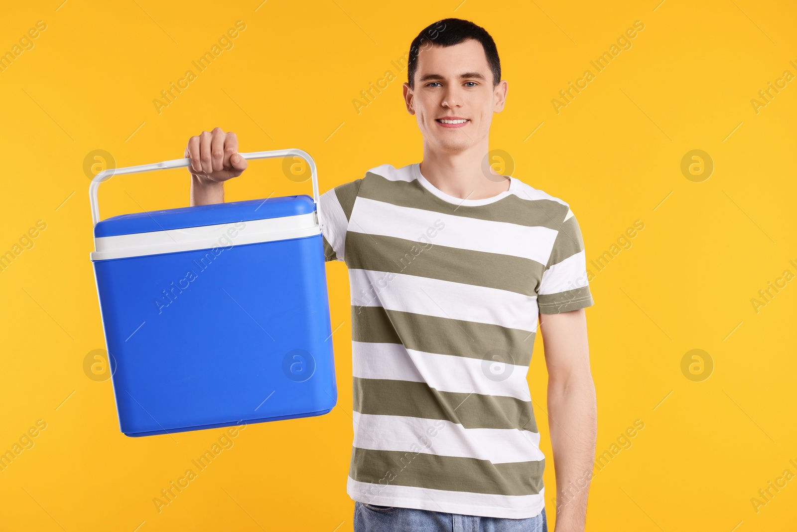 Photo of Man with blue cool box on orange background