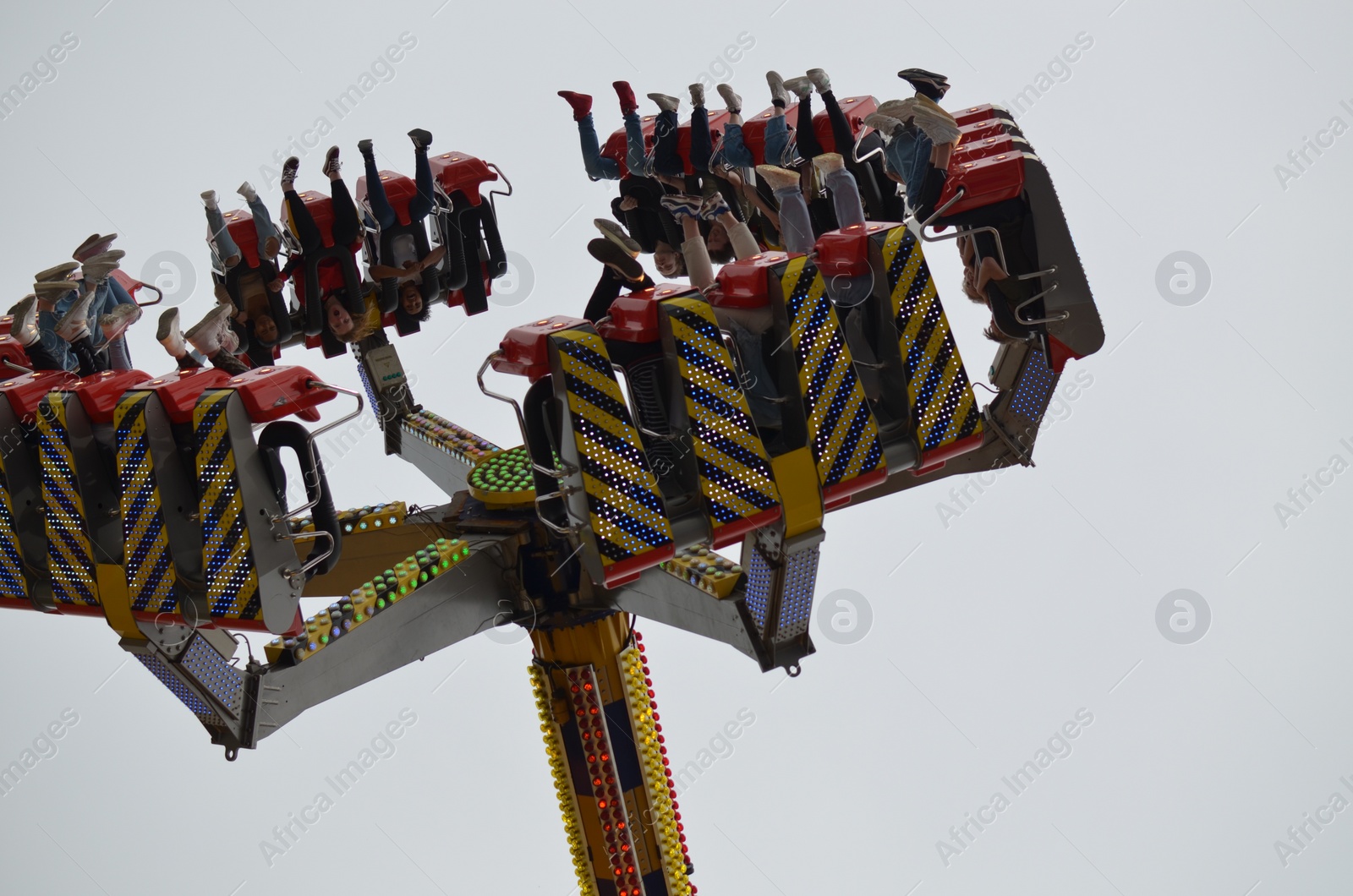 Photo of GRONINGEN, NETHERLANDS - MAY 20, 2022: People at pendulum ride attraction in outdoor amusement park