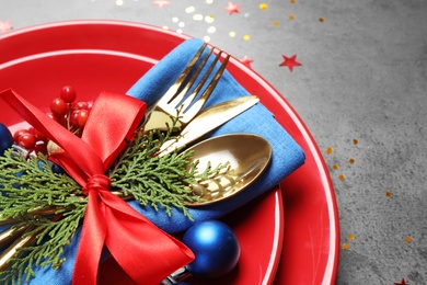 Beautiful Christmas table setting on grey background, closeup