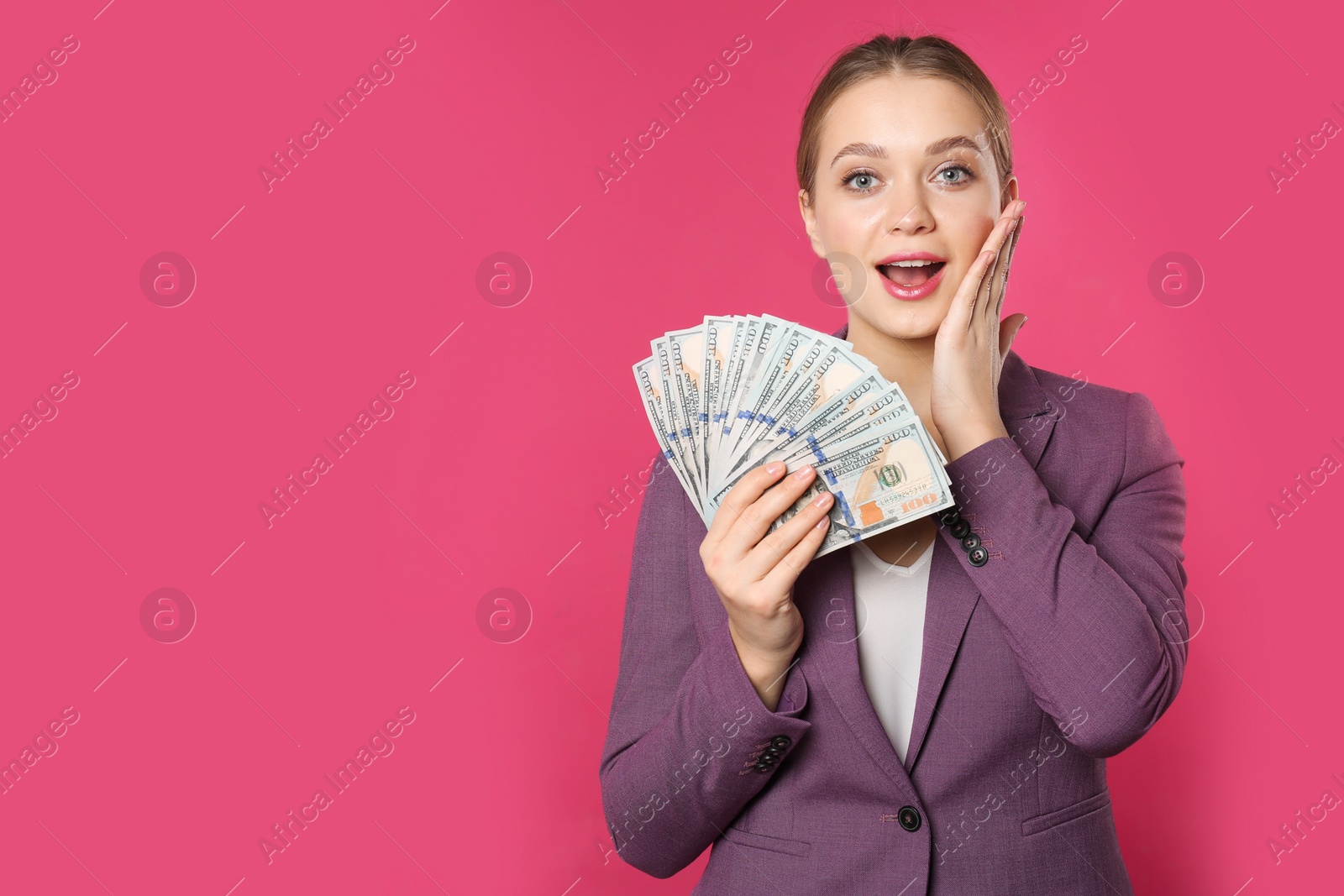 Photo of Portrait of emotional young businesswoman with money on color background. Space for text
