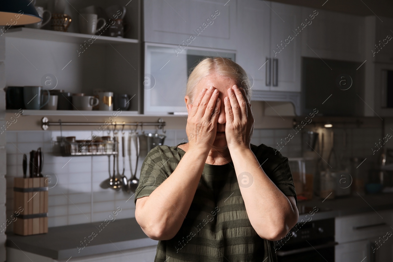 Photo of Mature woman suffering from depression at home