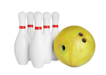 Photo of Yellow bowling ball and pins isolated on white